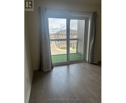 A room with a sliding glass door leading to a balcony.
