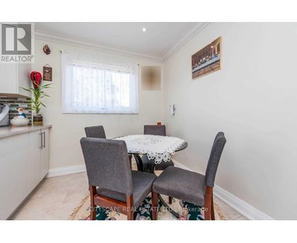 A dining room with a table and chairs.