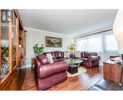 A living room with red leather couches and a glass coffee table.