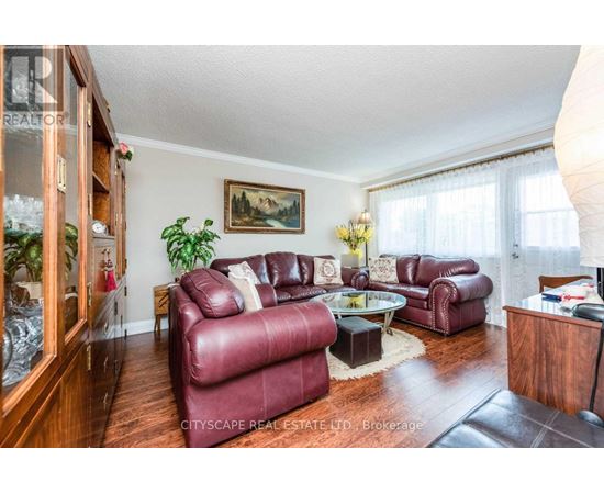 A living room with red leather couches and a glass coffee table.