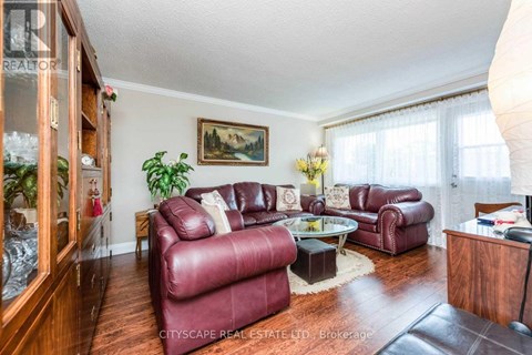A living room with red leather couches and a glass coffee table.