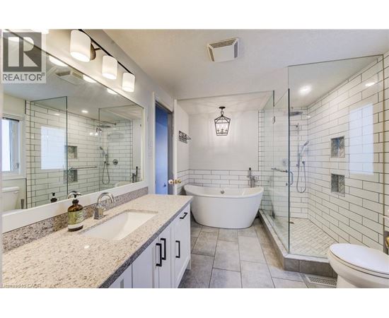 A bathroom with a white tub and a sink.
