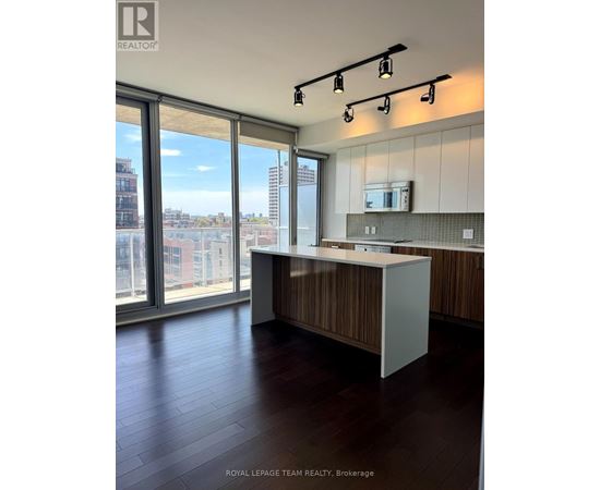 A modern kitchen with a view of the city.