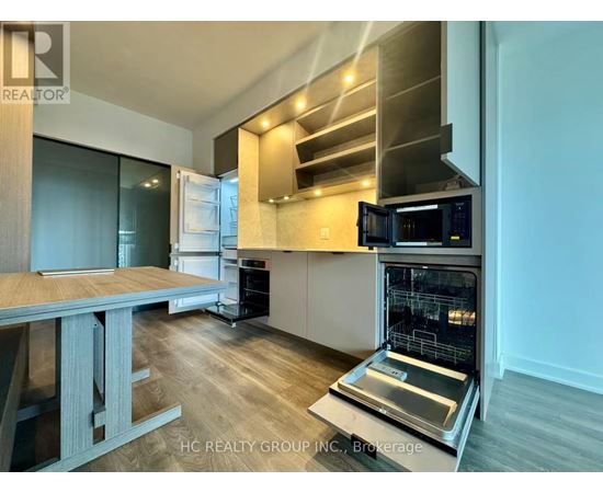 A modern kitchen with a stainless steel oven and microwave.
