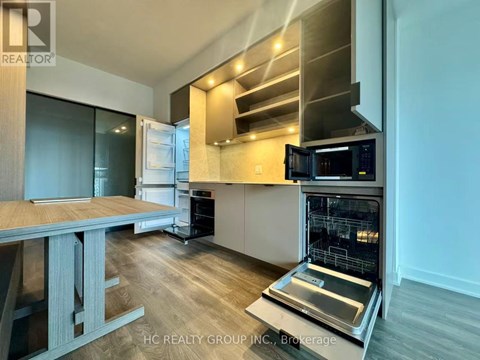 A modern kitchen with a stainless steel oven and microwave.