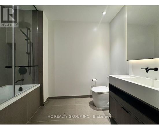A bathroom with a toilet, sink, and bathtub.