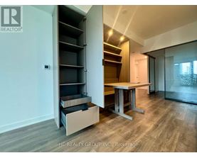 A room with a table and a cabinet with shelves.