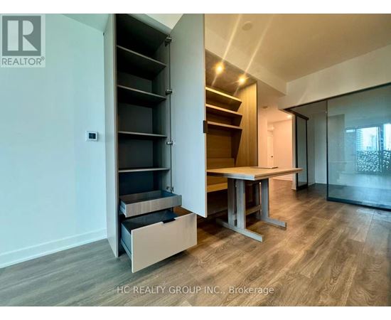 A room with a table and a cabinet with shelves.