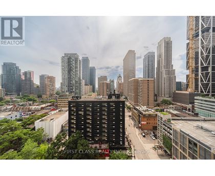 A cityscape with a building in the foreground that has the words "First Class Realty" on it.