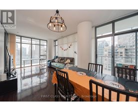 A dining room with a long table set for a meal.