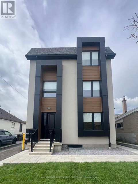A modern two-story house with a black and wood exterior.