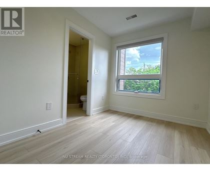 A room with a window and a door leading to another room.