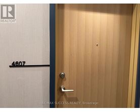 A door with a handle and a number 4607 on the wall.