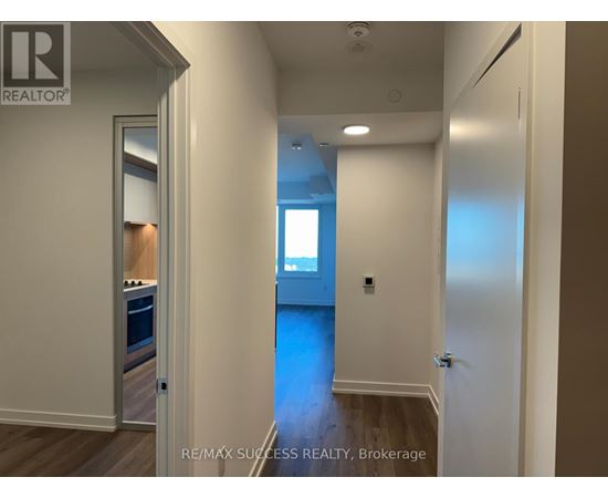 A hallway with a door on the left and a window on the right.
