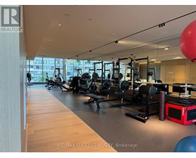 A gym with a variety of equipment including a red microwave.