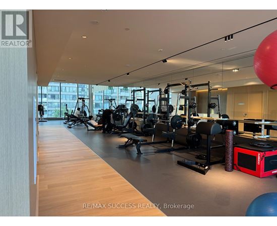 A gym with a variety of equipment including a red microwave.