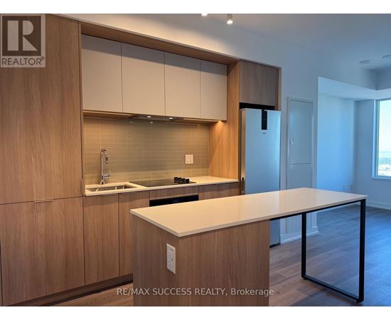 A modern kitchen with wooden cabinets and a white countertop.