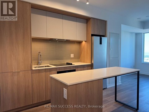 A modern kitchen with wooden cabinets and a white countertop.
