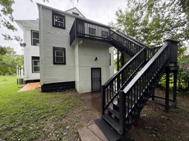 A house with a black staircase leading to the front door.