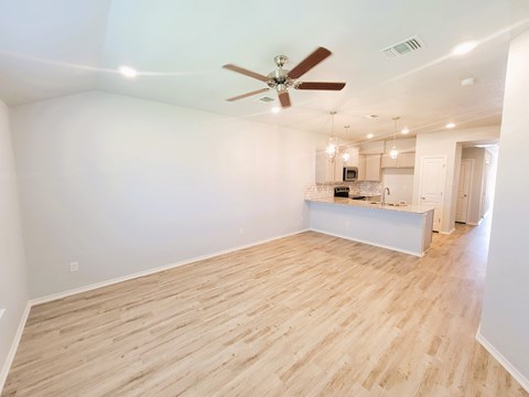 A room with a ceiling fan and lighting fixtures.