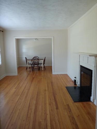 A room with a fireplace and a chair.