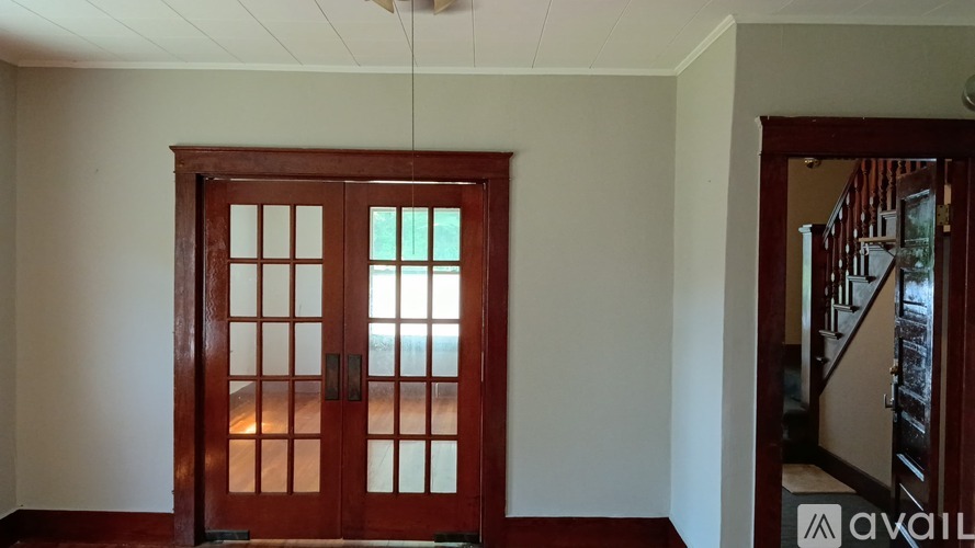 A room with a wooden door and a window.
