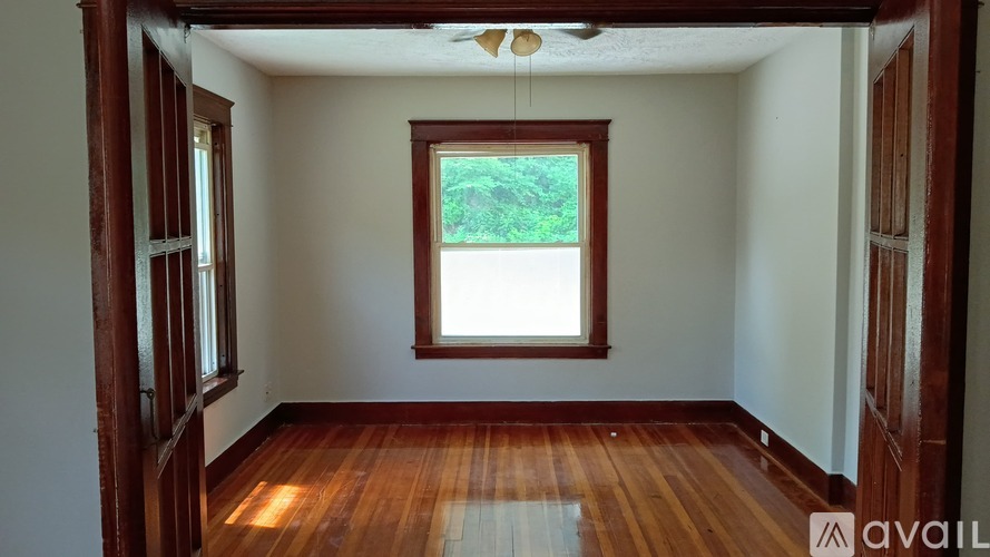 A room with wooden floors and a window.