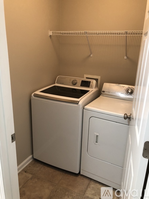 A small laundry room with a washer and dryer.
