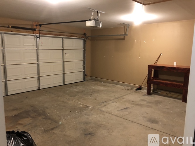 A garage with a white door and a brown wall.