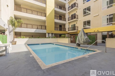 A swimming pool in a courtyard surrounded by apartment buildings.