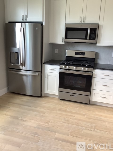 A kitchen with a stainless steel refrigerator and a stainless steel oven.