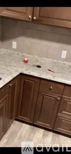 A kitchen counter with a red object on it.