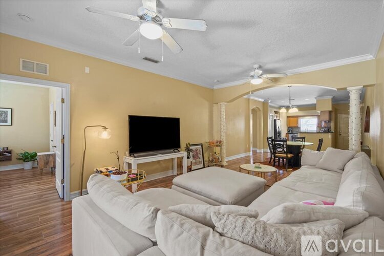 A living room with a large couch and a television.