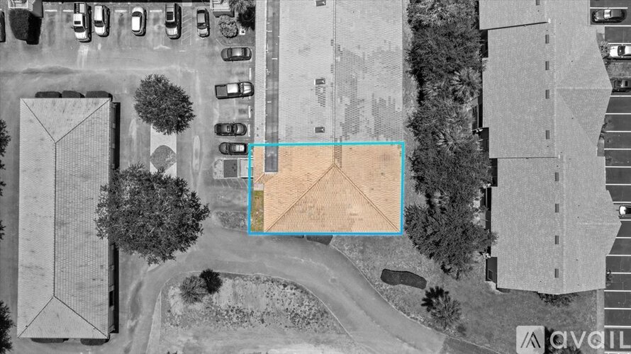An aerial view of a parking lot with a blue square highlighting a specific area.