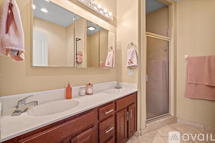 A bathroom with a sink, mirror, and towel rack.