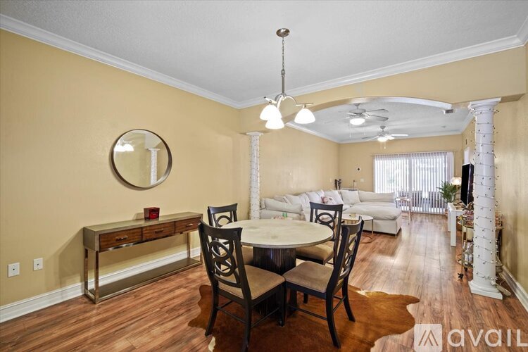 A dining room with a round table and chairs.