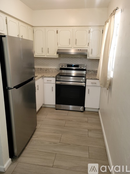 A kitchen with a stainless steel refrigerator and a stainless steel stove.