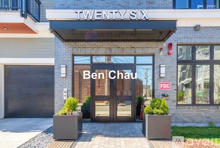 The entrance to a building named Twenty Six with a sign that reads Ben Chau.