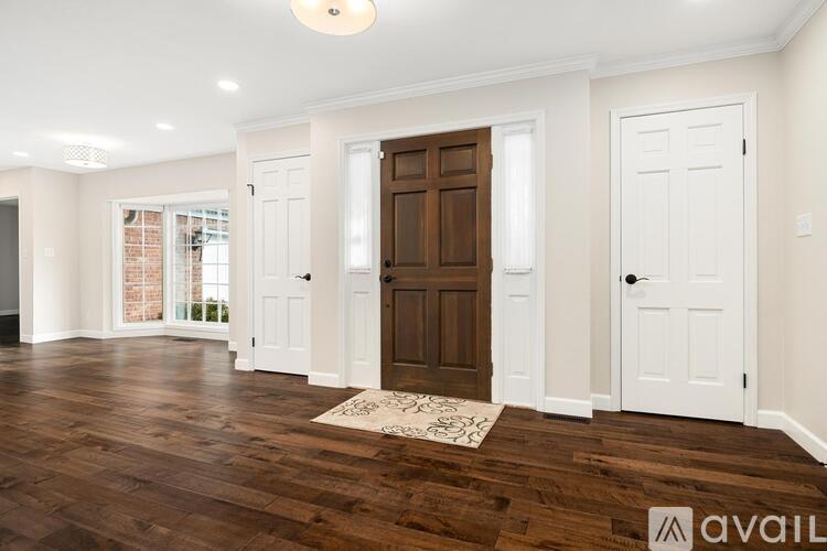 A room with a brown door and white walls.