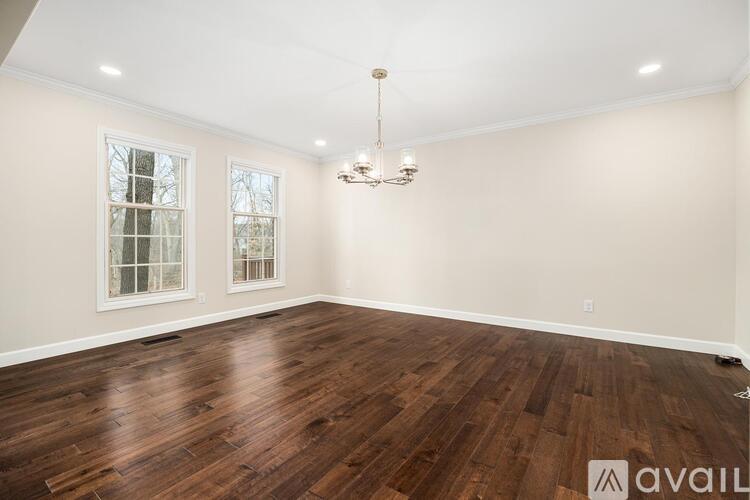 A room with wooden floors and a chandelier.