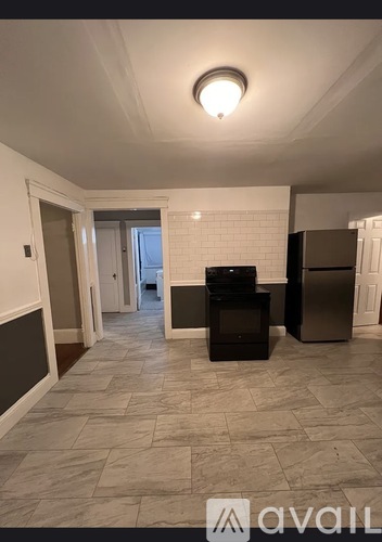 A kitchen area with a black fridge and a black oven.
