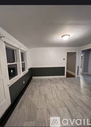A room with a tiled floor and a window.