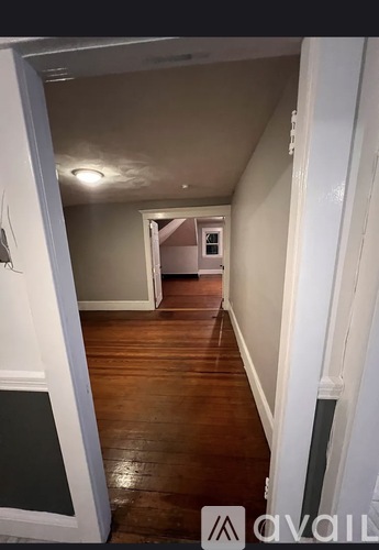 A hallway with a door on the left and a door on the right.