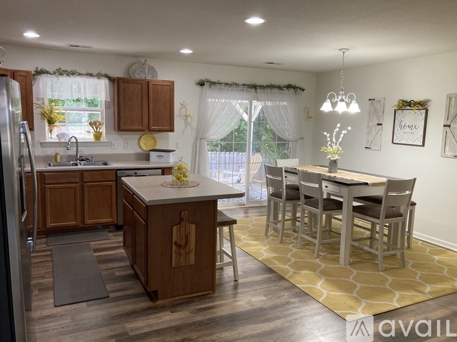 A kitchen with wooden cabinets and a white island.