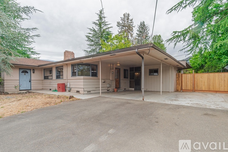 A house with a garage and a driveway is available for rent.