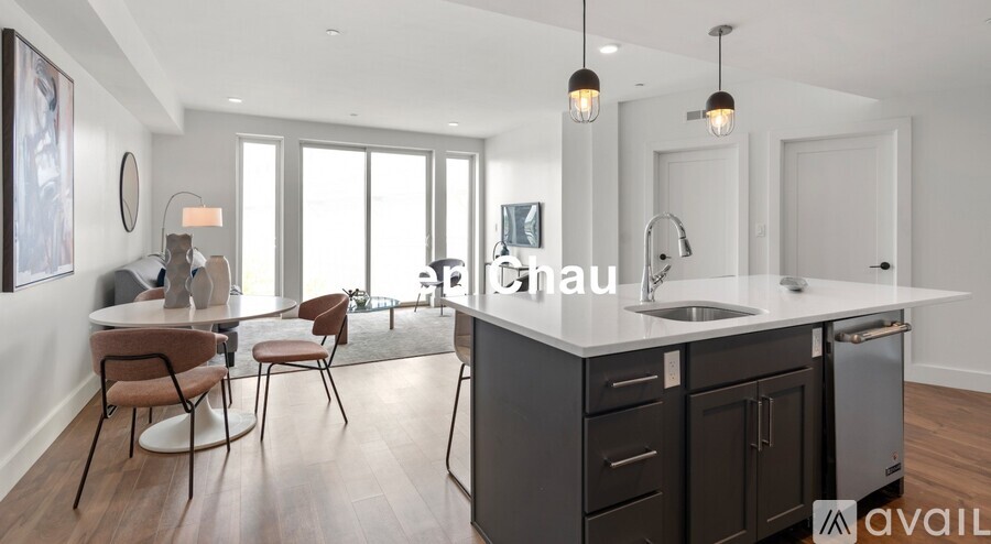 A modern kitchen with dark brown cabinets and a white countertop.