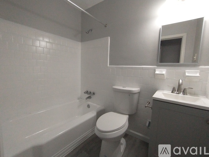A bathroom with a toilet, sink, and bathtub.