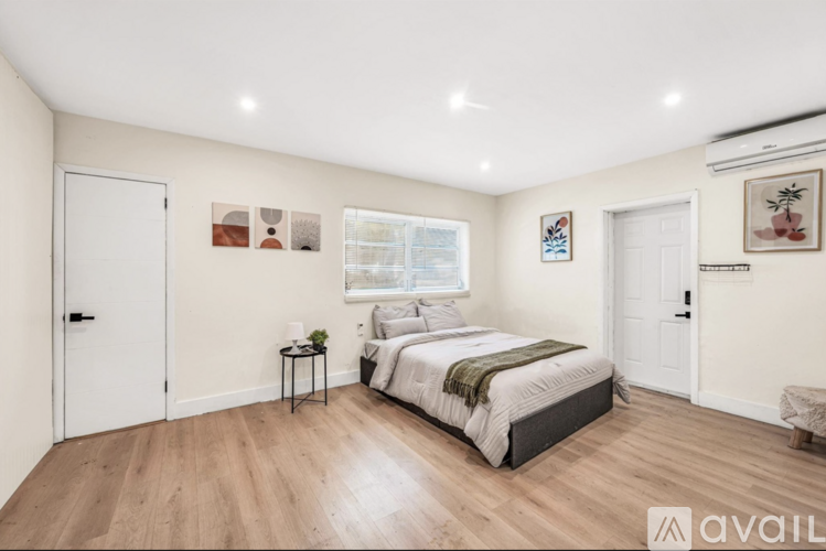A bedroom with a large bed and a window.