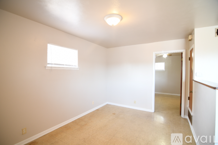 A room with a window and a door.