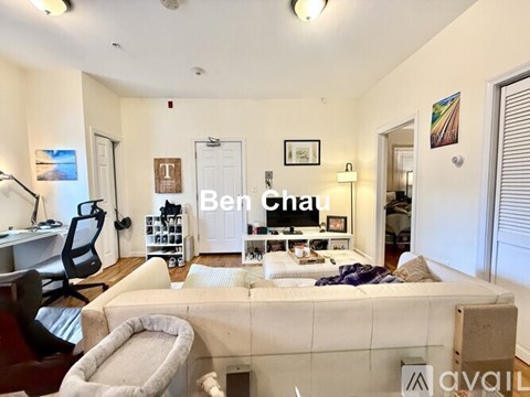A bedroom with a bed, desk, and chair, with the name "Ben Chau" on the wall.